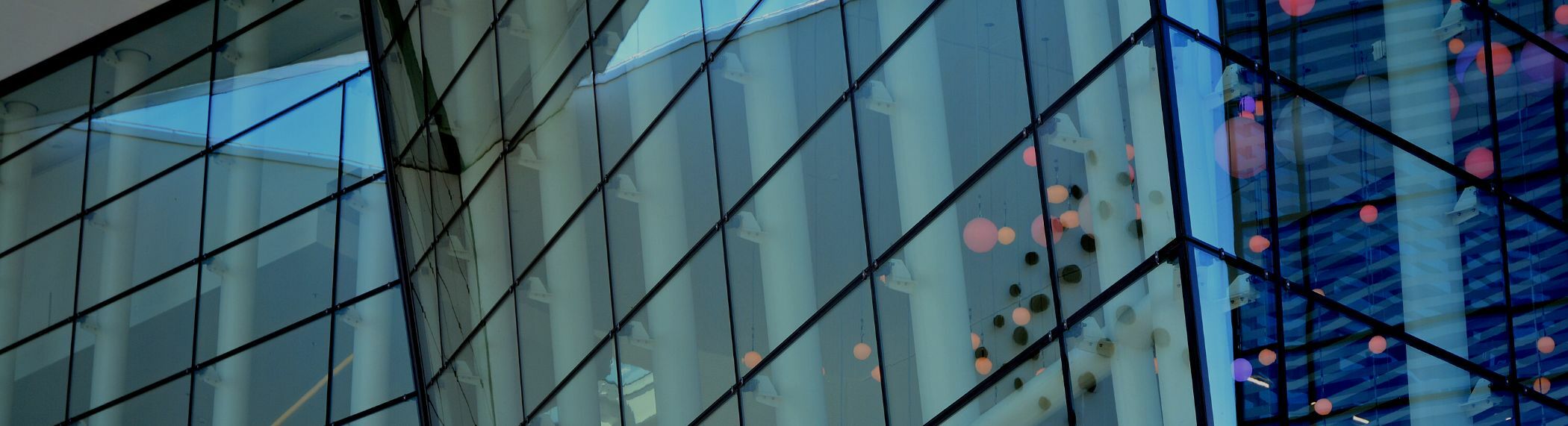 Close up of windows on a modern building with office buildings in the background